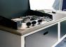 Kitchen includes a stainless steel 3-burner stove and running water with tap