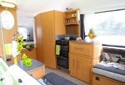 Folding Camper interior with oven, kitchen, wardrobe, seats and storage