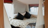 Warm and comfortable beds off the ground in Trailer Tents